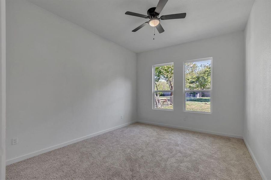 Unfurnished room featuring light carpet and ceiling fan