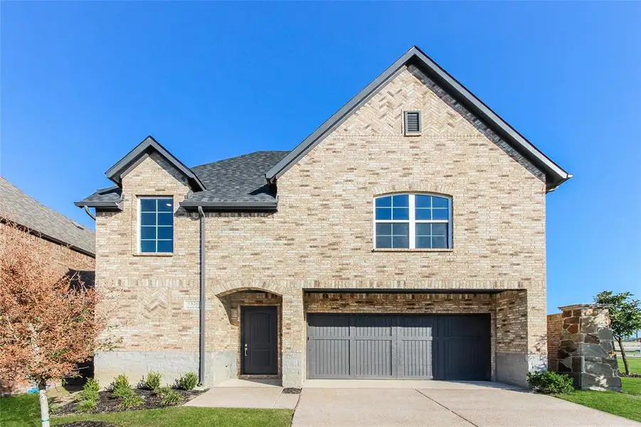 View of front facade featuring a garage