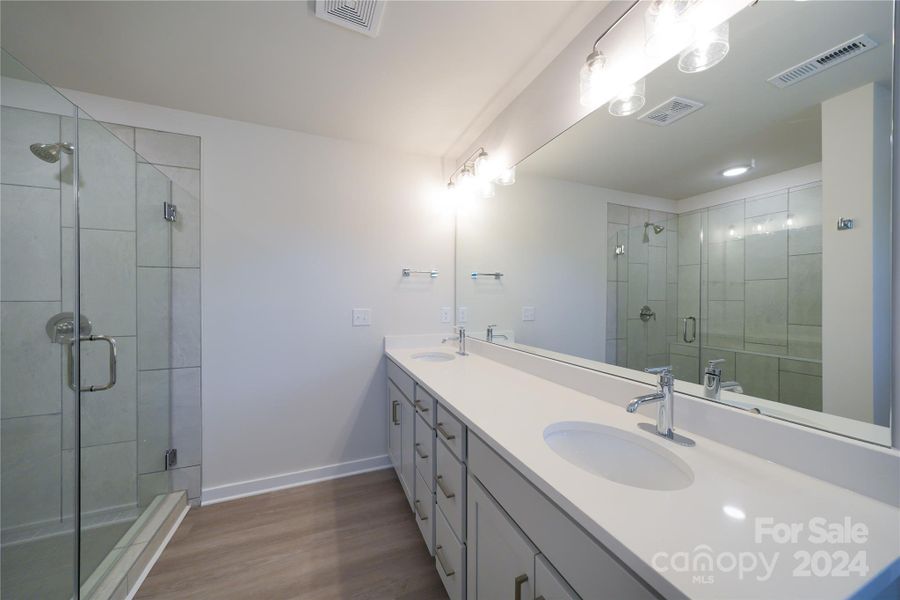 Primary Bathroom has upgraded cabinets, faucet package and lighting package.