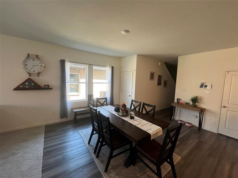 Dining room featuring dark wood-type flooring