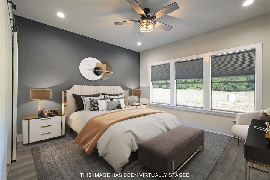 Primary Bedroom with ceiling fan, dark hardwood / wood-style floors, and multiple windows