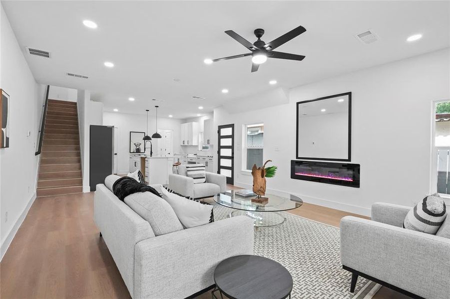 Living room featuring light wood-type flooring and ceiling fan