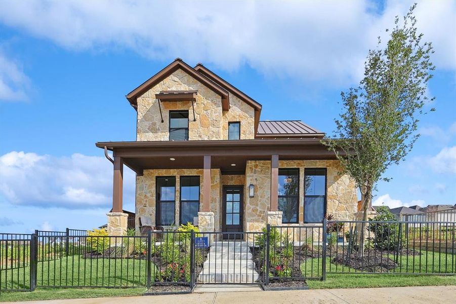 View of front of home with a front yard and covered porch