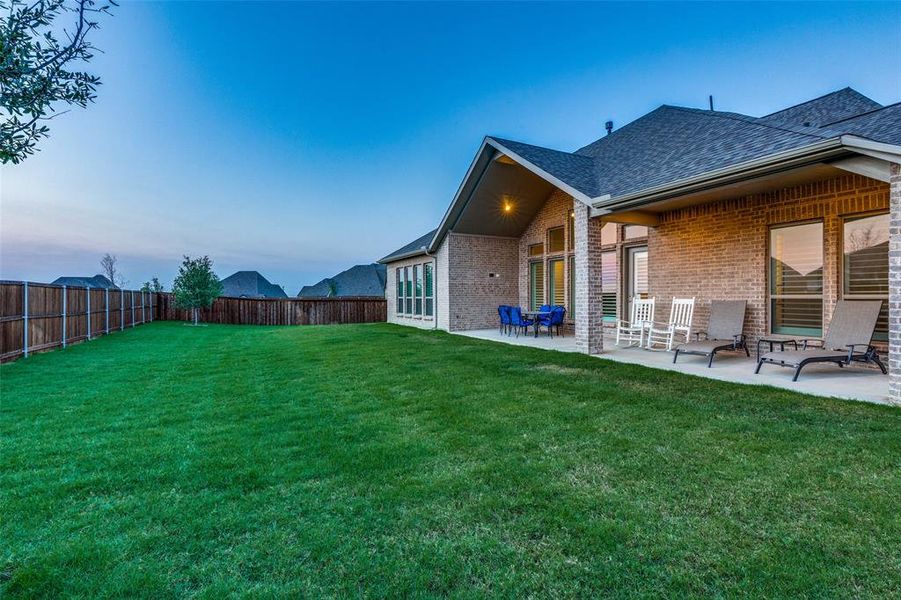 Yard at dusk with a patio area