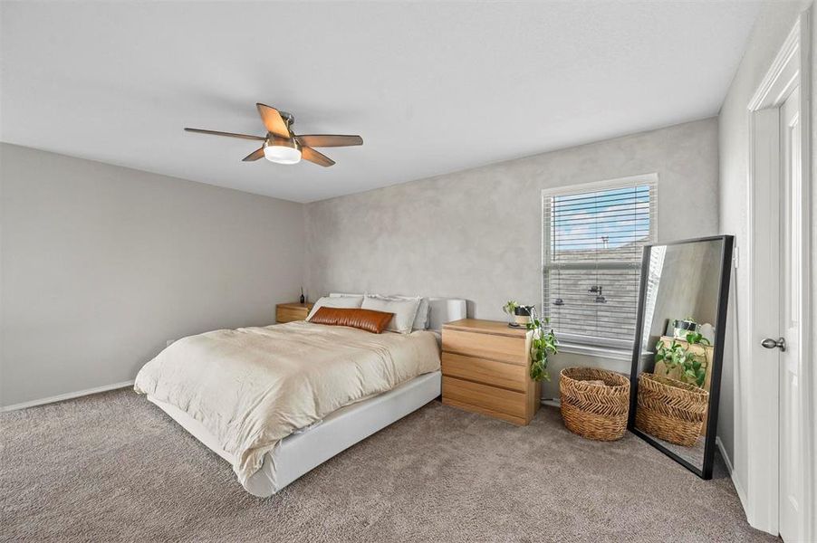 Bedroom with light carpet and ceiling fan