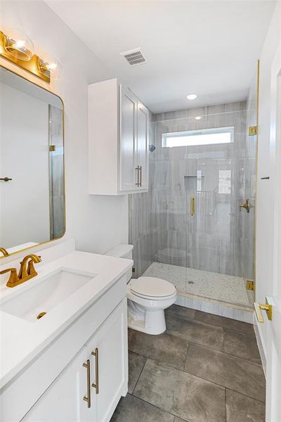 Bathroom with vanity, toilet, and walk in shower