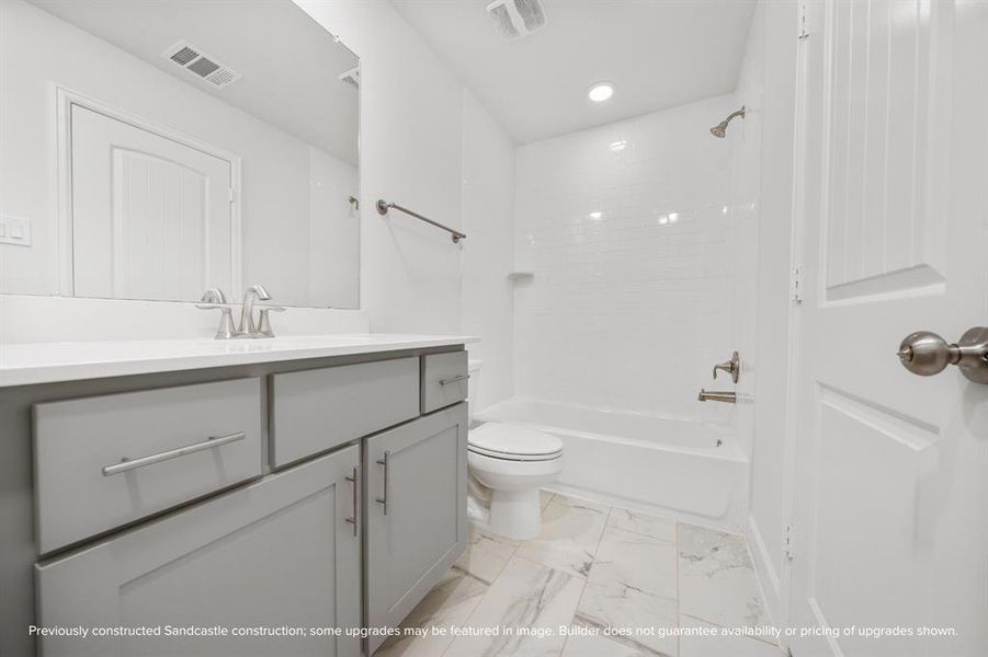 Shared convenience with a touch of classic design, this hall bathroom serves the game room and secondary bedrooms effortlessly.