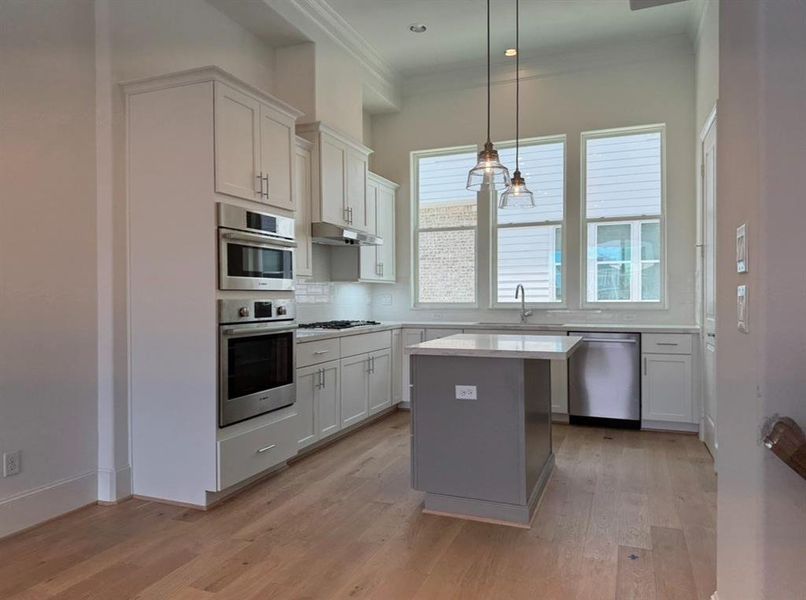 Island Kitchen with quartz countertops and stainless steel appliances