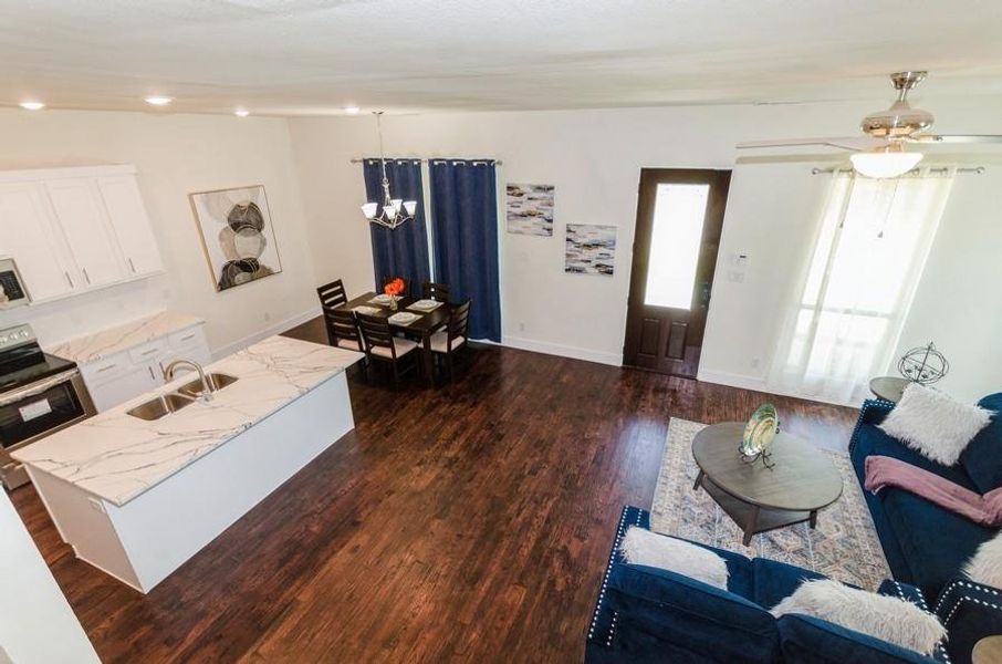 Living room featuring sink, ceiling fan, and dark hardwood / wood-style floors