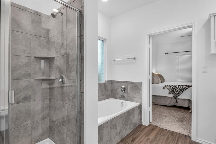 The primary bathroom features a walk-in shower and soaking tub.