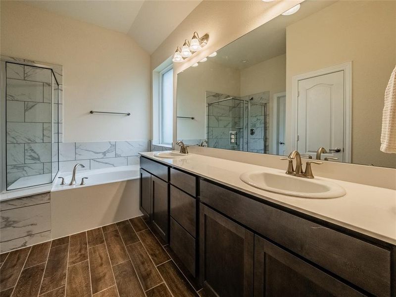 you have a frosted glass window, double vanities with granite counter tops  and the beautiful tile flooring , lots of storage for the primary also