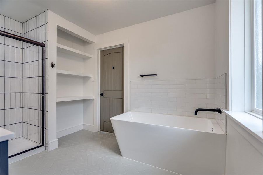 High end finishes abound in this totally redone home .  Take one look at this tasteful layout in the primary bath with some of the finest finishes in the area under one million.