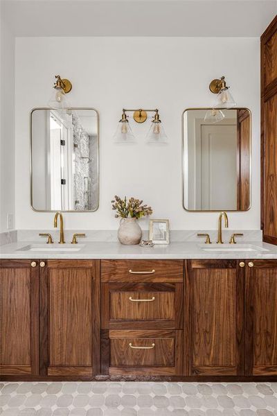 Custom walnut cabinetry and aged brass fixtures pair beautifully for a timeless look.