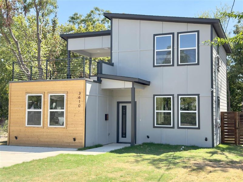 Contemporary home featuring a front lawn