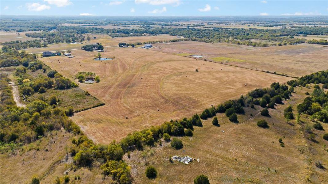 Birds eye view of property featuring a rural view