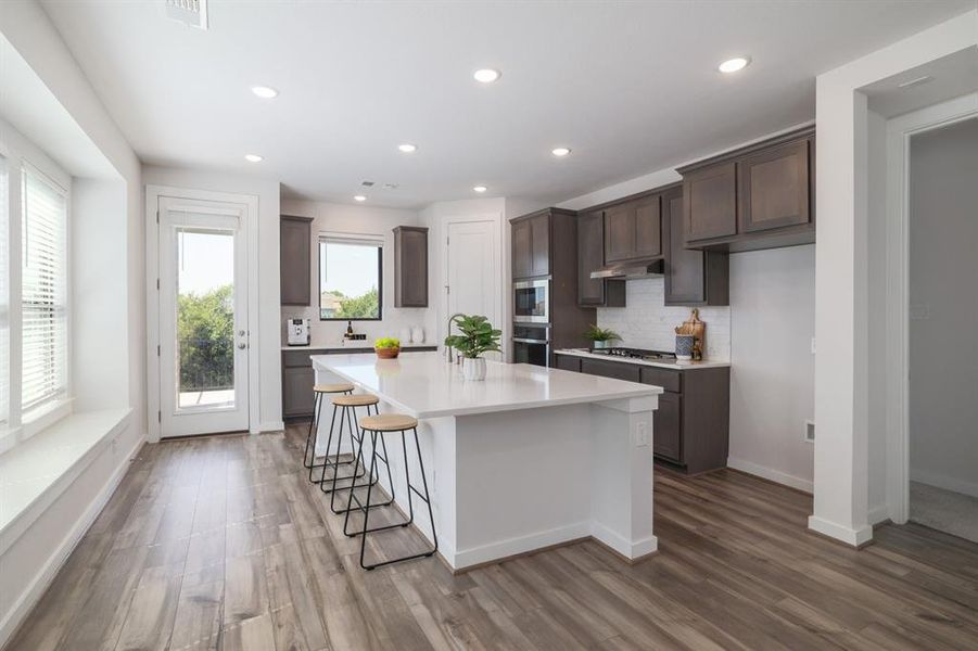 White quartz counters and dark wood tone cabinets compliment each other nicely.