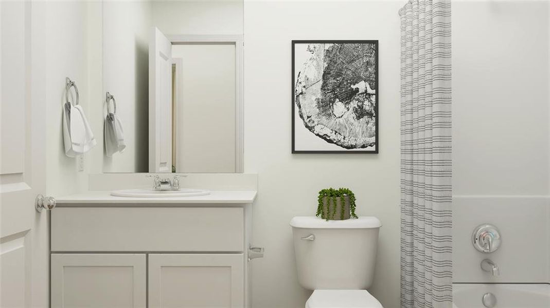 Bathroom featuring vanity, walk in shower, and toilet