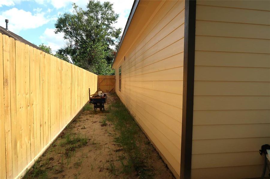 View of side of home with all new fencing for privacy.