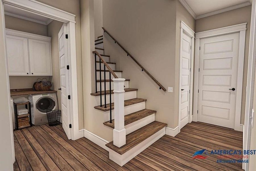 Staircase featuring ornamental molding, dark hardwood / wood-style flooring, and washer / dryer