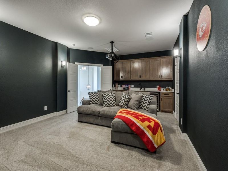 Living room featuring wine cooler and light colored carpet