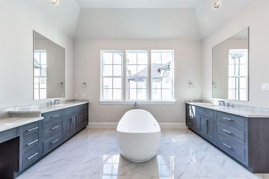 Primary bath with dual sinks and soaking tub.