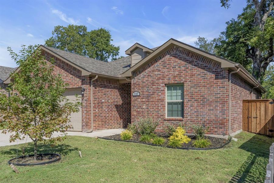 View of front of property with a garage and a front lawn