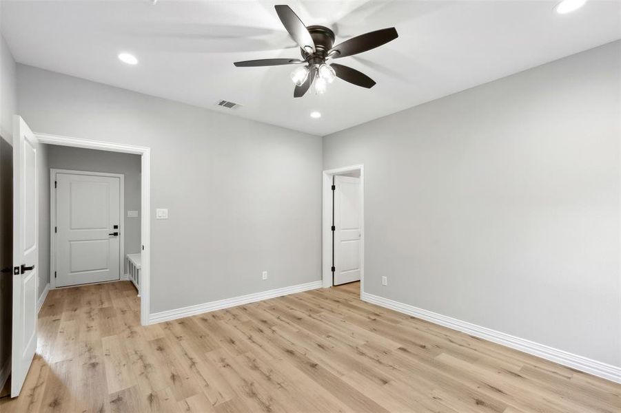 Unfurnished bedroom with ceiling fan, a closet, and light wood-type flooring