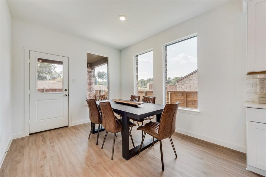 Dining space with light hardwood / wood-style flooring