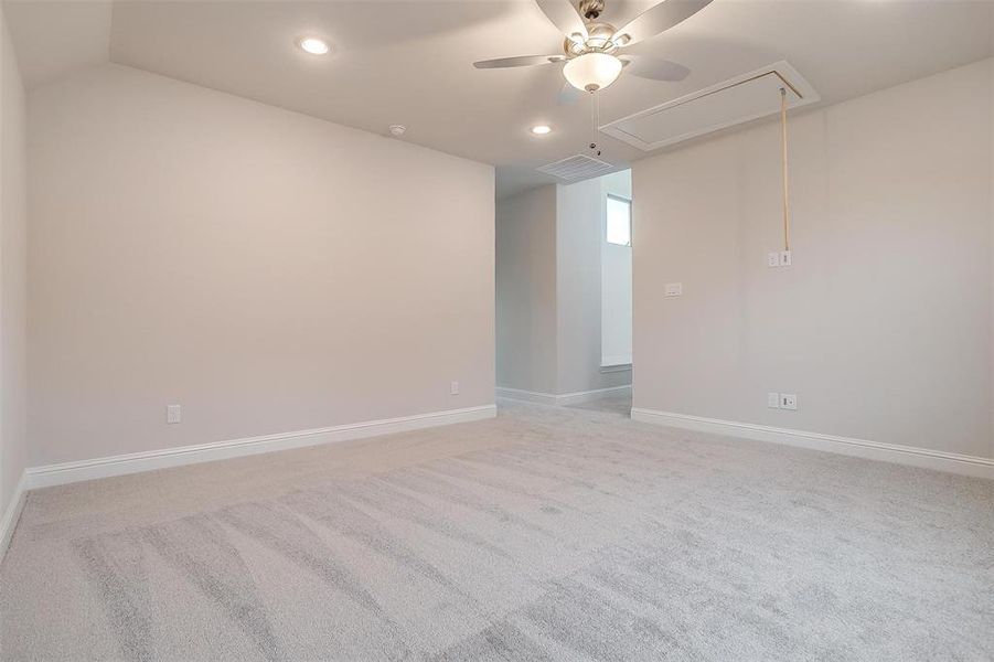 Carpeted spare room featuring ceiling fan