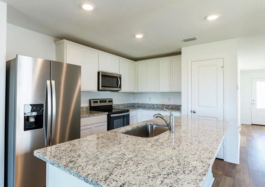 The kitchen is chef-ready with stainless steel appliances