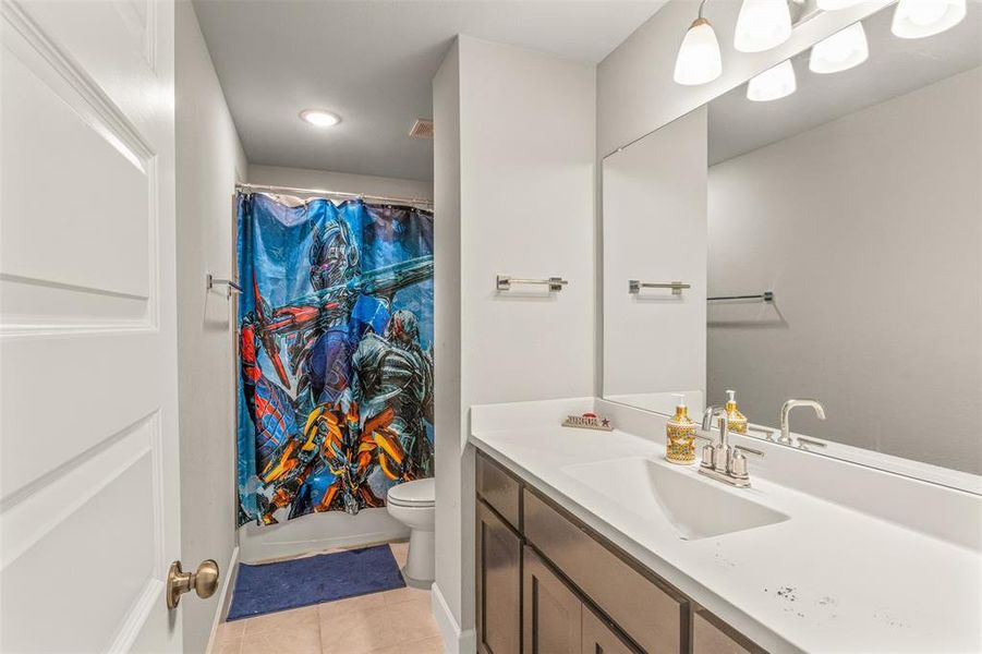 Bathroom with tile patterned floors, toilet, and vanity