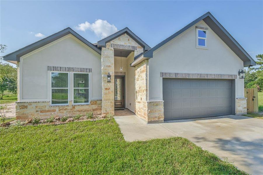 Lovely elevation with stone and brick accents.