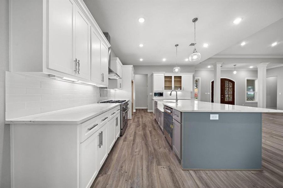 Ample work space between island and cabinets. Upper cabinets are 42" tall with crown moulding.