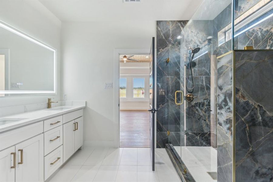 Bathroom with vanity, ceiling fan, wood-type flooring, and a shower with door