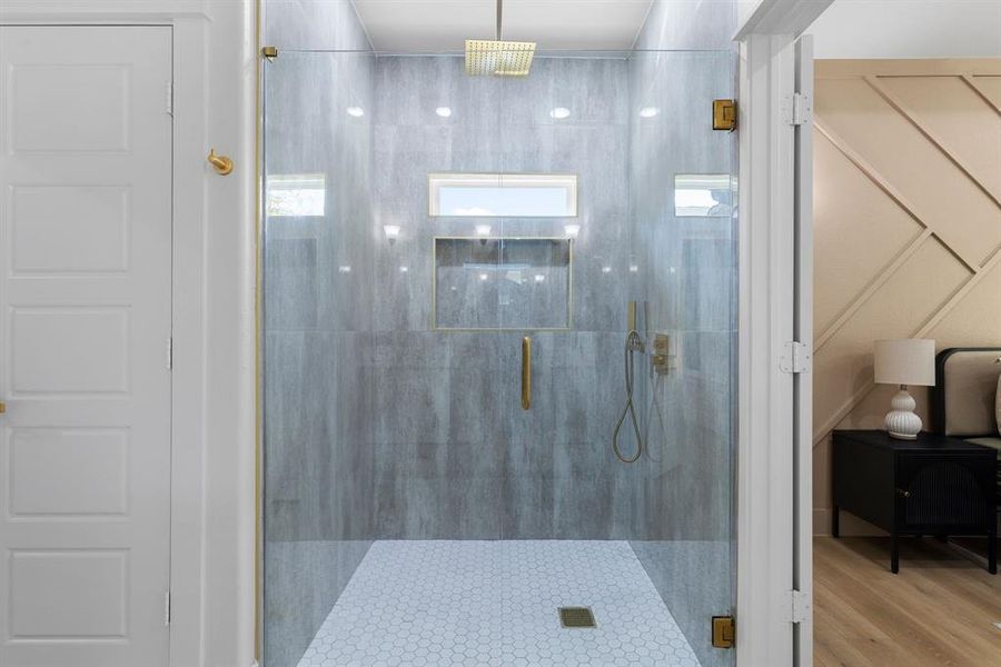 Bathroom featuring an enclosed shower and hardwood / wood-style floors