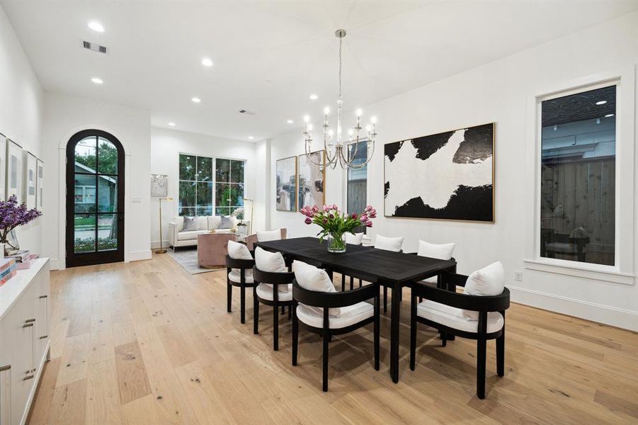 Entrance with Formal Living Room that is open to the Formal Dining Room. There is a Chandelier finished in Polished Nickel in the Dining Room.