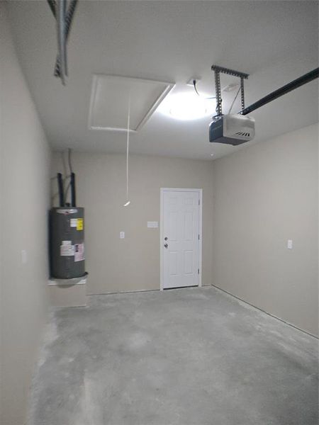 Garage with water heater and a garage door opener