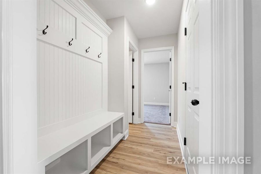 Mudroom with light hardwood / wood-style floors