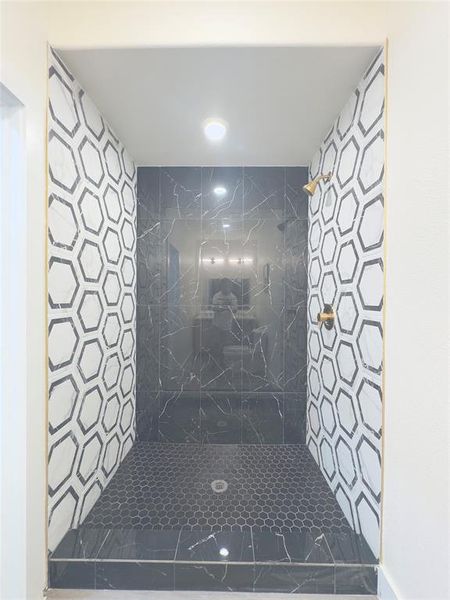 Bathroom featuring a tile shower