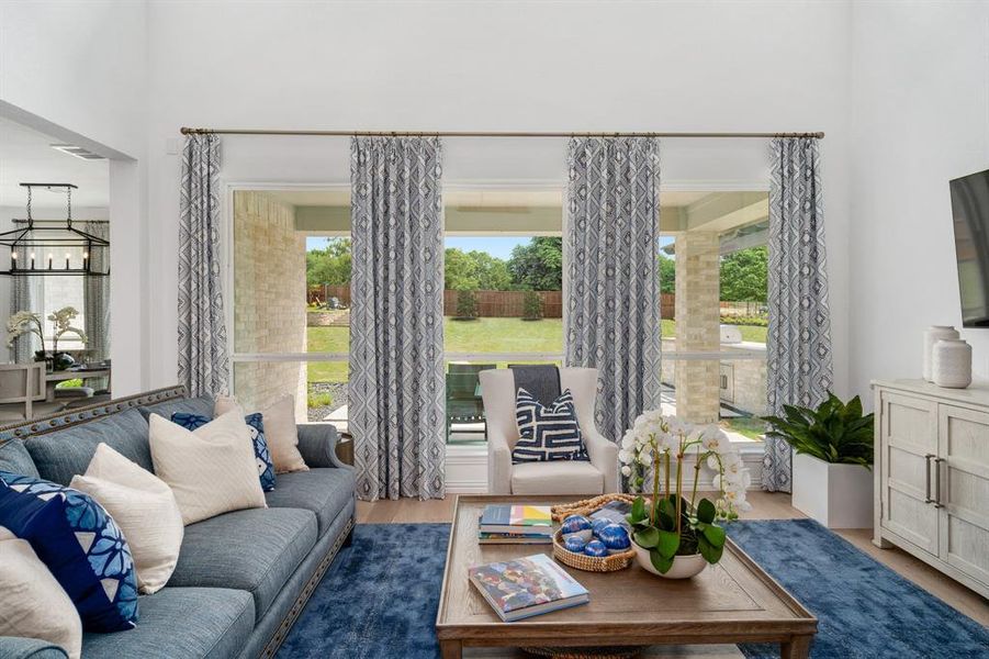 Living room featuring hardwood / wood-style flooring, an inviting chandelier, and plenty of natural light