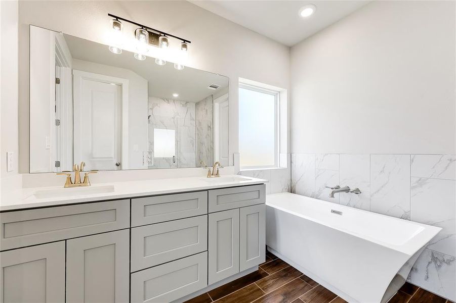 His and her sinks on a light granite countertop.