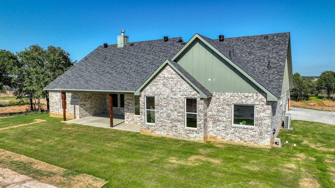 Back of property featuring a patio and a yard