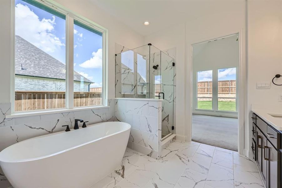 Bathroom with vanity, a wealth of natural light, and tile patterned flooring