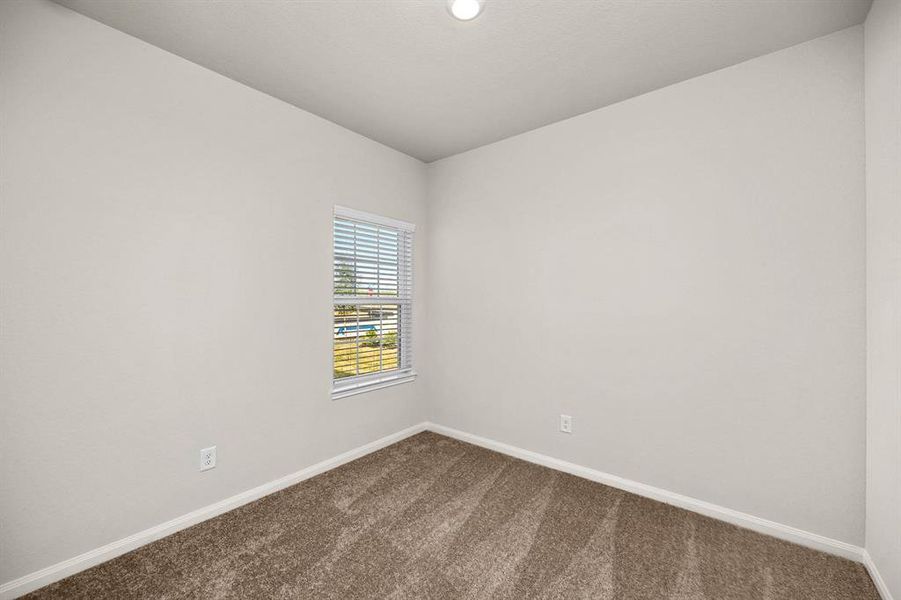 One of the two additional bedrooms in the home.