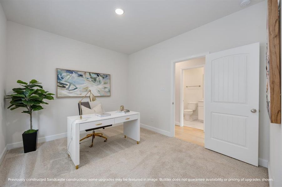 A secondary bedroom on the second floor presents a perfect blend of comfort and functionality, complete with a desk, window, and proximity to the shared hall bathroom.