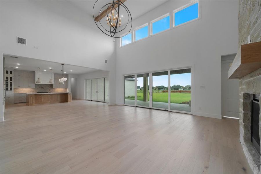 Unfurnished living room featuring a fireplace, light wood-type flooring, and plenty of natural light