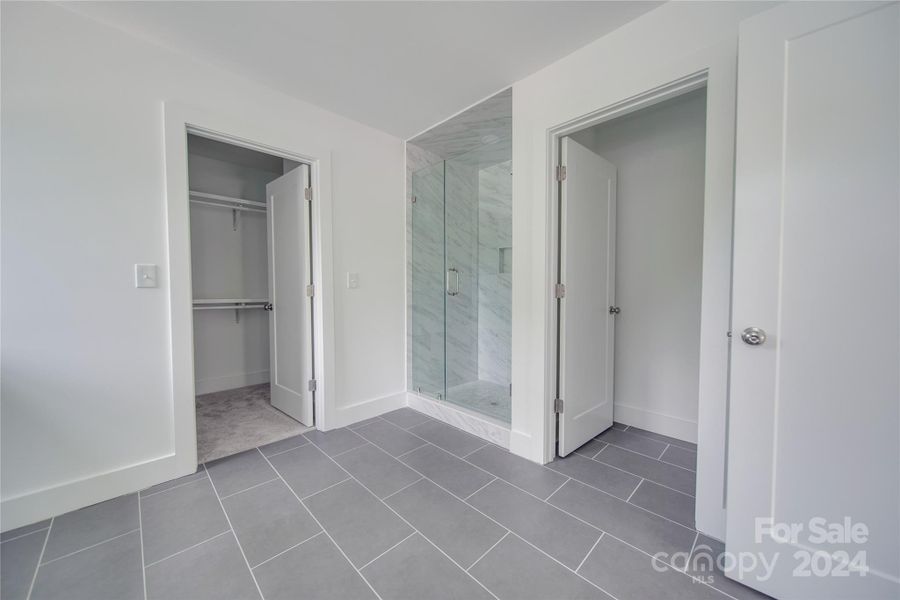 PRIMARY BATHROOM FEATURING WALK IN CLOSET