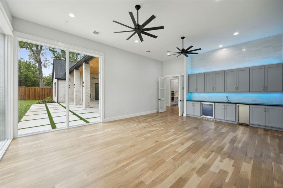 Downstairs Gameroom with Two Walls of Floor to Ceiling  Pella Windows; Bar with Beverage Cooler, Ice Maker; Sink