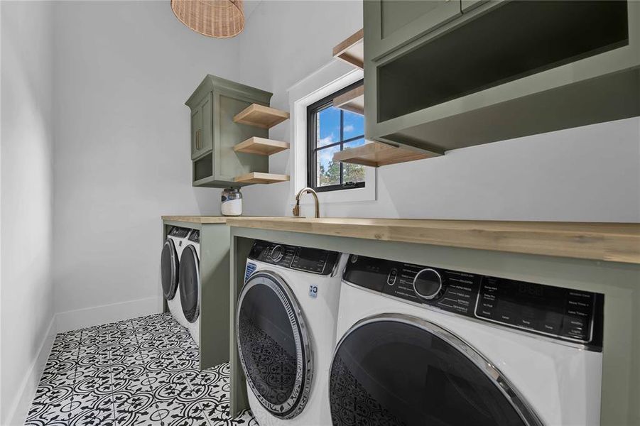 Custom utility room with double washers and dryers- they convey