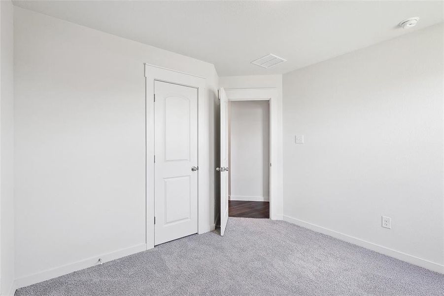 Unfurnished bedroom with carpet